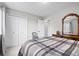 This bedroom has white walls, two double door closets, light carpet, and wooden furniture at 5133 S Liverpool Way, Centennial, CO 80015
