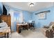 Bright blue room with desk, chair, and large window offering lots of natural light at 5133 S Liverpool Way, Centennial, CO 80015