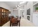 Open dining room showcasing a fireplace and views to other rooms with neutral walls and plenty of natural light at 5133 S Liverpool Way, Centennial, CO 80015