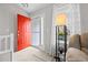 Bright entryway featuring a vibrant red door and ample natural light from the adjacent window at 5133 S Liverpool Way, Centennial, CO 80015