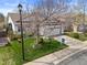 Well-maintained home with lush lawn, garden beds, and a 'For Sale' sign at 5133 S Liverpool Way, Centennial, CO 80015
