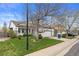 Attractive home exterior with mature trees, green lawn, and inviting curb appeal at 5133 S Liverpool Way, Centennial, CO 80015
