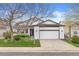 Lovely home with a manicured lawn, garden beds, and a two car garage at 5133 S Liverpool Way, Centennial, CO 80015