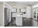 Bright kitchen with white cabinets, stainless steel appliances, and a center island with barstool seating at 5133 S Liverpool Way, Centennial, CO 80015