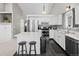 Well-lit kitchen featuring white cabinets, stainless steel appliances, and a convenient center island at 5133 S Liverpool Way, Centennial, CO 80015
