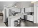 Modern kitchen with white cabinetry, stainless steel appliances, a stylish backsplash, and a kitchen island at 5133 S Liverpool Way, Centennial, CO 80015