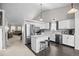 Bright kitchen with white cabinets, stainless steel appliances, and black and white backsplash at 5133 S Liverpool Way, Centennial, CO 80015