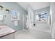 Bright main bathroom featuring dual sinks, a soaking tub, and a separate glass shower at 5133 S Liverpool Way, Centennial, CO 80015