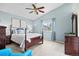 Light-filled main bedroom with blue walls, vaulted ceiling, and elegant furniture at 5133 S Liverpool Way, Centennial, CO 80015