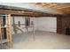 Unfinished basement ready for customization with exposed beams and a brick fireplace at 6775 S Sherman St, Centennial, CO 80122