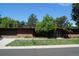 Single story brick home with a garage and a yard, under a sunny blue sky at 6775 S Sherman St, Centennial, CO 80122