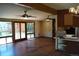Open living room with hardwood floors, ceiling fans, and access to an outdoor deck at 6775 S Sherman St, Centennial, CO 80122
