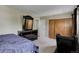Bedroom with carpet, closet, dresser with mirror, and an electric massage chair at 5546 S Quemoy Cir, Aurora, CO 80015