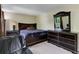 Bedroom featuring a dark wood bedroom set, carpeted floor, and natural light at 5546 S Quemoy Cir, Aurora, CO 80015