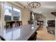 A dining room with light wood floors, table with seating, and chandelier lighting at 5546 S Quemoy Cir, Aurora, CO 80015