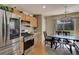 Bright eat-in kitchen features stainless steel appliances, plenty of counter space, and a breakfast table at 5546 S Quemoy Cir, Aurora, CO 80015