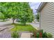 Landscaped front yard featuring a beautiful lawn, mature trees, and colorful rose bushes enhancing curb appeal at 5546 S Quemoy Cir, Aurora, CO 80015