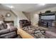 Cozy living room featuring hardwood floors, stylish furniture, and a modern decorative mirror at 5546 S Quemoy Cir, Aurora, CO 80015