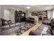 Open-concept living room features hardwood floors, a large TV, and comfortable seating at 5546 S Quemoy Cir, Aurora, CO 80015