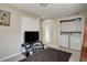 Comfortable living room with TV, modern media center, stylish rug, and in-unit laundry for convenient living at 5546 S Quemoy Cir, Aurora, CO 80015