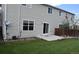 Back of house with lawn, patio, and sliding glass door, windows, and neutral siding at 5546 S Quemoy Cir, Aurora, CO 80015