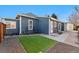 View of the fenced backyard with low maintenance turf and access to the home at 3300 W 2Nd Ave, Denver, CO 80219