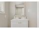 Bathroom featuring a vanity with white cabinets, marble countertop and a framed mirror at 3300 W 2Nd Ave, Denver, CO 80219