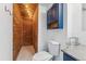 Cozy bathroom featuring a stylish toilet, a cabinet with wooden accents, and bright lighting for a modern feel at 3300 W 2Nd Ave, Denver, CO 80219