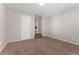 Comfortable bedroom featuring neutral walls, a carpeted floor, and direct access to the lower level stairs at 3300 W 2Nd Ave, Denver, CO 80219