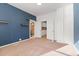 Spacious bedroom with modern floating shelves, plush carpeting, and a connecting door to an en-suite bathroom at 3300 W 2Nd Ave, Denver, CO 80219