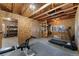 The detached bonus room features wood rafters, gym equipment, and storage space at 3300 W 2Nd Ave, Denver, CO 80219