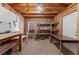 Bonus room featuring exposed rafters, storage and work tables at 3300 W 2Nd Ave, Denver, CO 80219