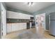 A well-lit kitchen featuring ample cabinetry and stainless steel appliances for modern convenience at 3300 W 2Nd Ave, Denver, CO 80219