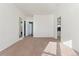 Spacious living area featuring neutral paint, plush carpeting, and an adjacent hallway at 3300 W 2Nd Ave, Denver, CO 80219