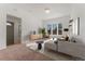 Bright living room featuring a large bay window, plush carpeting, and neutral decor at 3300 W 2Nd Ave, Denver, CO 80219