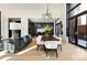 Bright dining area next to an open kitchen, featuring a modern, decorative lighting fixture at 100 Detroit St # 103, Denver, CO 80206