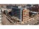 Modern, multi-story building with a curved facade, showcasing contemporary architecture in an urban setting near shops and businesses at 100 Detroit St # 103, Denver, CO 80206