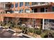 Exterior of an apartment building with well-maintained landscaping, including trees and planters, offering outdoor living space at 100 Detroit St # 103, Denver, CO 80206