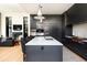 The kitchen features an eat-in island, modern appliances, and opens up to the living room at 100 Detroit St # 103, Denver, CO 80206