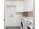 A clean and bright laundry room with modern appliances at 100 Detroit St # 103, Denver, CO 80206