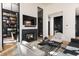 Modern living space featuring a fireplace, TV, and a bar area, providing an elegant and functional space at 100 Detroit St # 103, Denver, CO 80206