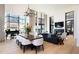 Open concept living area featuring modern decor, a dining table, piano, and a fireplace, all bathed in natural light at 100 Detroit St # 103, Denver, CO 80206