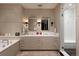 This neutral-toned main bathroom features a walk-in shower and separate tub at 100 Detroit St # 103, Denver, CO 80206