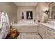 This bathroom features a soaking tub and dual vanities at 100 Detroit St # 103, Denver, CO 80206