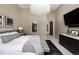 Well-lit main bedroom boasting natural light, a comfy bed, neutral colors, and dark wood furniture at 100 Detroit St # 103, Denver, CO 80206