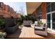 Charming patio area with a water feature, comfortable seating, and a mix of stone and wood surfaces at 100 Detroit St # 103, Denver, CO 80206