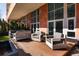 Relaxing patio with modern outdoor furniture, manicured greenery, and ample space for entertaining at 100 Detroit St # 103, Denver, CO 80206