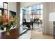 View of a piano sitting adjacent to a window with a view of the exterior of the home at 100 Detroit St # 103, Denver, CO 80206