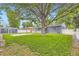 Spacious backyard featuring lush lawn, mature trees, shed, and privacy fence at 5150 W Colgate Pl, Denver, CO 80236