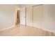 Bedroom featuring hardwood floors, closet doors, and entry to en suite bathroom at 5150 W Colgate Pl, Denver, CO 80236